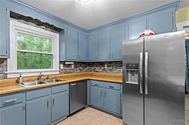 2465 W Deerpath Dr, Powhatan, VA 23139 - kitchen featuring appliances with stainless steel finishes, a sink, backsplash, and blue cabinets