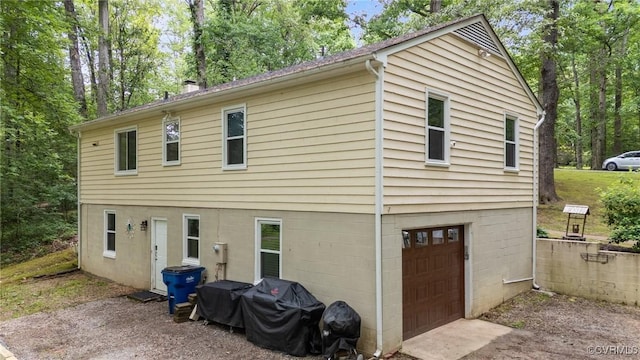 2465 W Deerpath Dr, Powhatan, VA 23139 - rear view of house with an attached garage and a chimney
