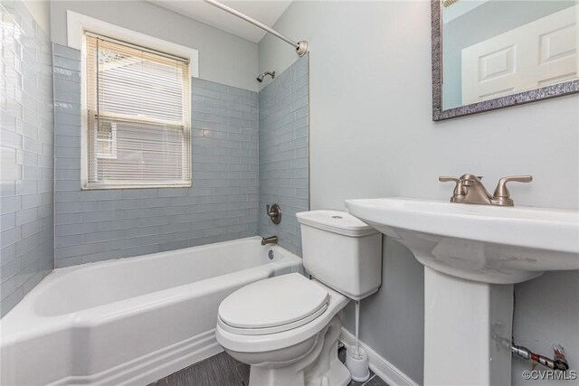 25 Cherry St, Petersburg, VA 23803 - bathroom featuring toilet, bathing tub / shower combination, baseboards, wood finished floors, and a sink