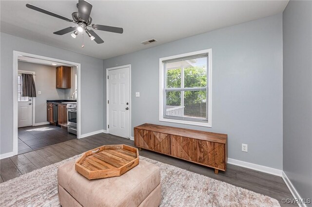25 Cherry St, Petersburg, VA 23803 - living room featuring dark wood-type flooring, baseboards, and a ceiling fan