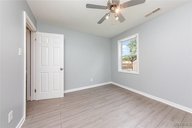 25 Cherry St, Petersburg, VA 23803 - empty room featuring wood finished floors, baseboards, and a ceiling fan