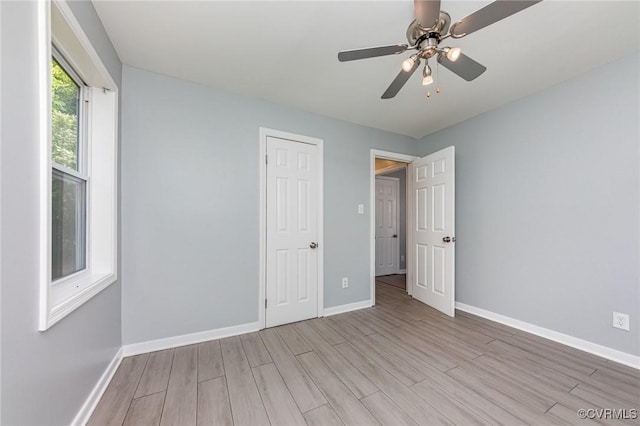 25 Cherry St, Petersburg, VA 23803 - unfurnished bedroom with baseboards, wood finished floors, and a ceiling fan