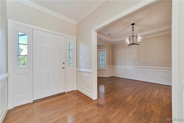 1355 Hawkins Wood Cir, Midlothian, VA 23114 - foyer featuring a chandelier, wood finished floors, a decorative wall, ornamental molding, and wainscoting