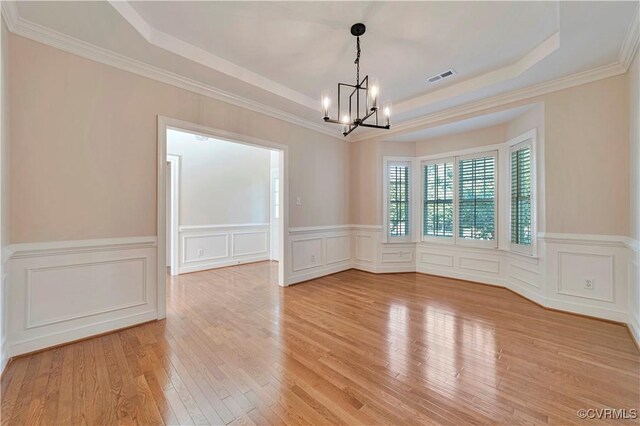 1355 Hawkins Wood Cir, Midlothian, VA 23114 - unfurnished room with a raised ceiling, a chandelier, wood-type flooring, a decorative wall, and a wainscoted wall