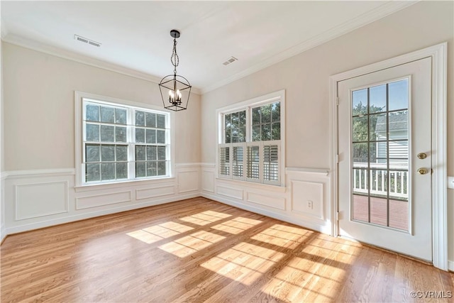 1355 Hawkins Wood Cir, Midlothian, VA 23114 - unfurnished dining area featuring a chandelier, light wood-style floors, a wainscoted wall, and ornamental molding