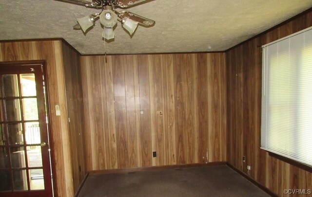 27701 W Prince Edward Hwy, Burkeville, VA 23922 - carpeted empty room featuring wood walls, ceiling fan, a textured ceiling, and baseboards