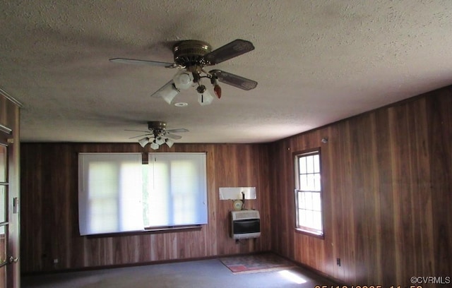 27701 W Prince Edward Hwy, Burkeville, VA 23922 - unfurnished room featuring heating unit, a textured ceiling, wooden walls, and a ceiling fan