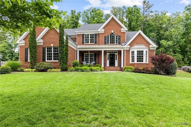 16412 Ravenchase Way, Moseley, VA 23120 - view of front facade with a standing seam roof, a front lawn, covered porch, brick siding, and a metal roof