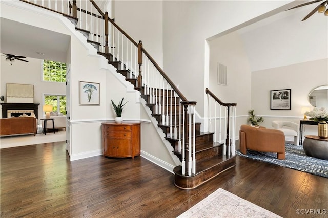 16412 Ravenchase Way, Moseley, VA 23120 - stairs featuring a ceiling fan, a high ceiling, wood finished floors, and a fireplace