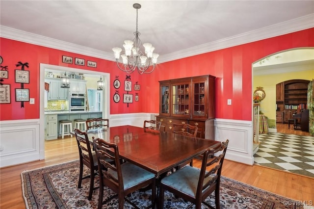9226 Shelton Pointe Dr, Mechanicsville, VA 23116 - dining room with a chandelier, wainscoting, crown molding, and wood finished floors