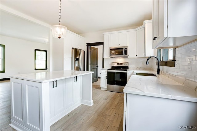 170 Glenmore Ln, Keswick, VA 22947 - kitchen featuring appliances with stainless steel finishes, a sink, a kitchen island, decorative backsplash, and white cabinets