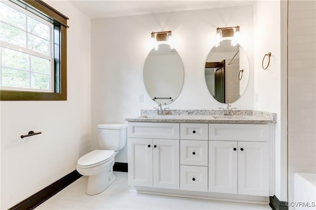 170 Glenmore Ln, Keswick, VA 22947 - bathroom with double vanity, baseboards, toilet, and a bath