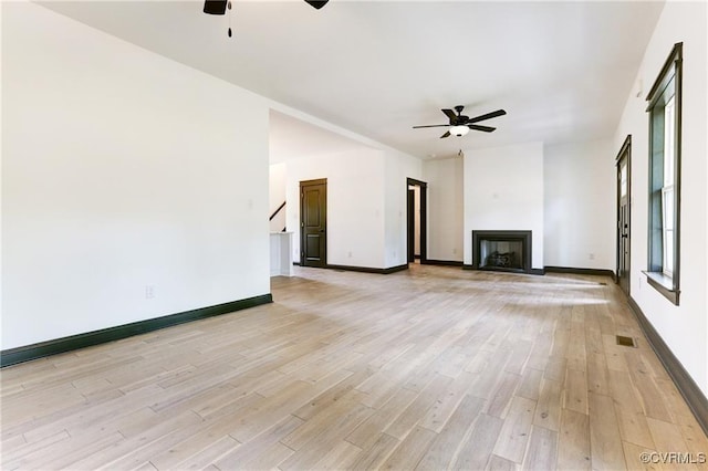 170 Glenmore Ln, Keswick, VA 22947 - unfurnished living room featuring ceiling fan, light wood-style floors, a fireplace, and baseboards