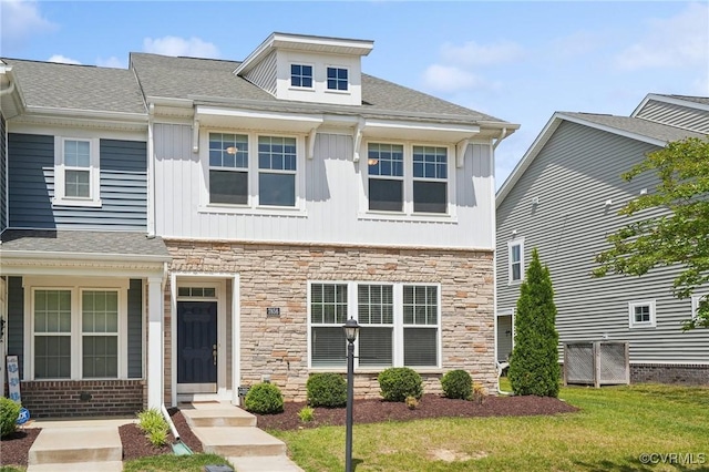 7856 Vermeil St, North Chesterfield, VA 23237 - view of front of property with stone siding, a front lawn, board and batten siding, and a shingled roof