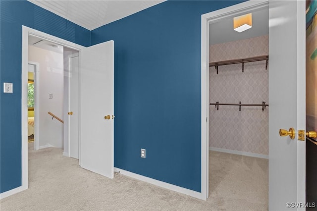 unfurnished bedroom featuring carpet, a closet, and baseboards