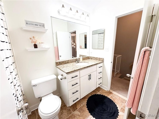 full bathroom featuring toilet, vanity, baseboards, and tile patterned floors