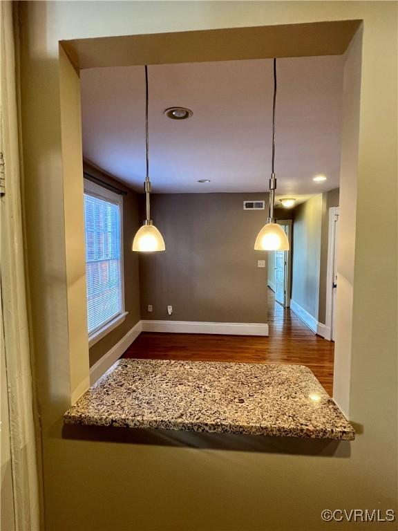 unfurnished dining area with wood finished floors, baseboards, and recessed lighting