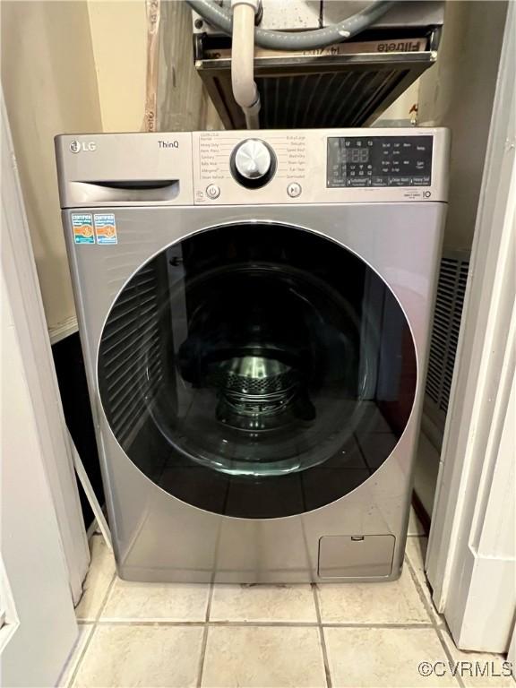 laundry area featuring washer / dryer and tile patterned floors