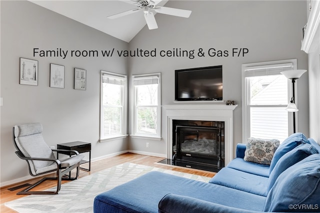 living area featuring high vaulted ceiling, a fireplace with flush hearth, baseboards, a ceiling fan, and wood finished floors