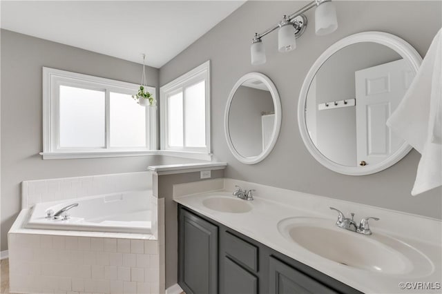 bathroom featuring a bath and double vanity