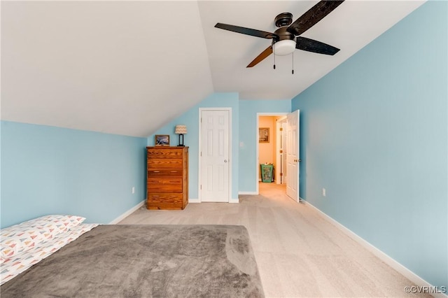 unfurnished bedroom with lofted ceiling, carpet, ceiling fan, and baseboards