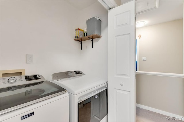 washroom with washer and clothes dryer and baseboards