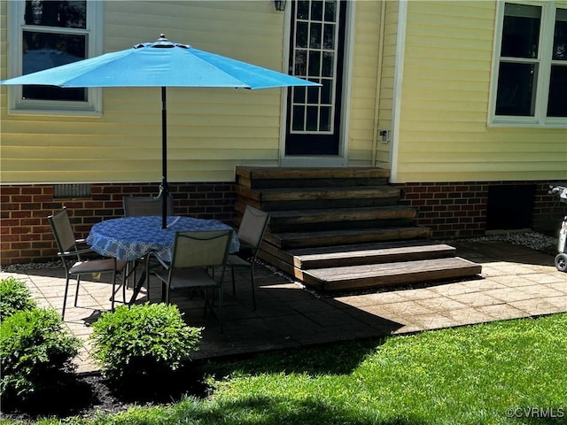 view of patio featuring entry steps and outdoor dining area