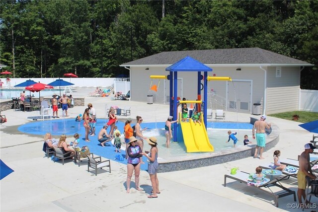 surrounding community featuring fence, a swimming pool, and a patio area