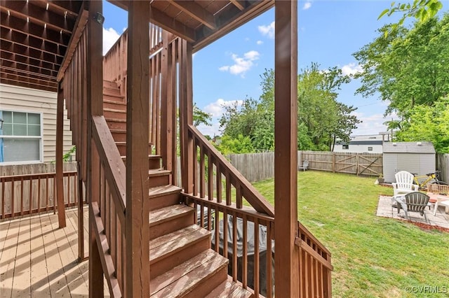 1415 N 25th St, Richmond, VA 23223 - wooden terrace featuring stairway, a storage unit, an outbuilding, and a patio area
