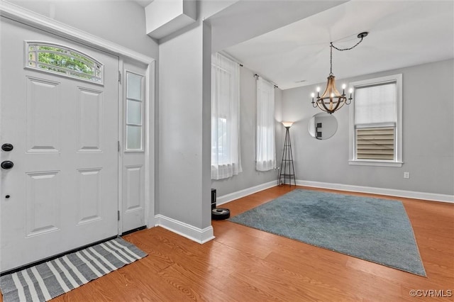 1415 N 25th St, Richmond, VA 23223 - foyer entrance with a chandelier, wood finished floors, and baseboards