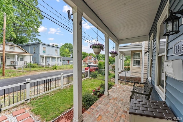 1415 N 25th St, Richmond, VA 23223 - view of patio with a porch, fence, and a residential view