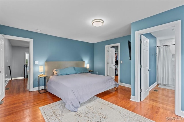 1415 N 25th St, Richmond, VA 23223 - bedroom featuring a walk in closet, wood finished floors, baseboards, and a closet