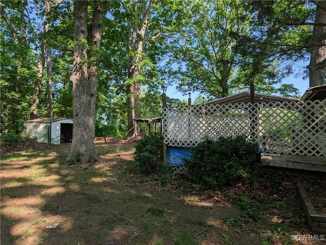 1555 Holly Hills Rd, Powhatan, VA 23139 - view of yard featuring a storage shed, an outbuilding, and a deck