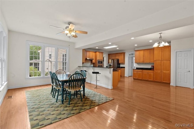 dining room with a chandelier, light wood-type flooring, ceiling fan, baseboards, and recessed lighting