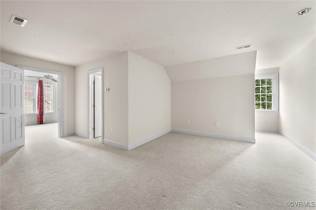 unfurnished room featuring light colored carpet and baseboards