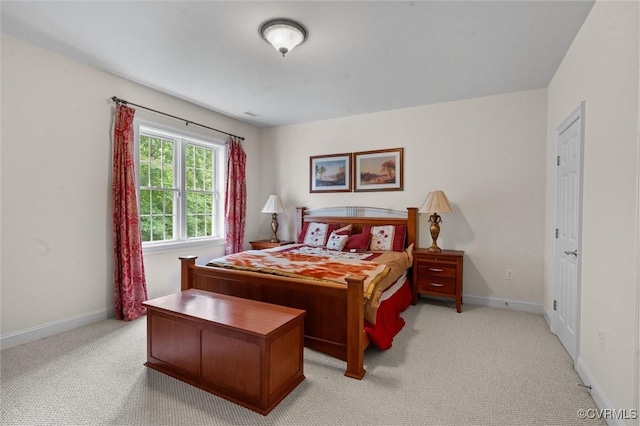 bedroom with light carpet and baseboards