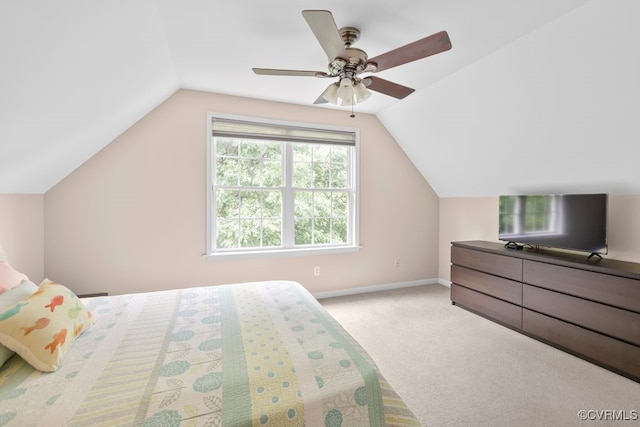 bedroom featuring lofted ceiling, light carpet, baseboards, and a ceiling fan