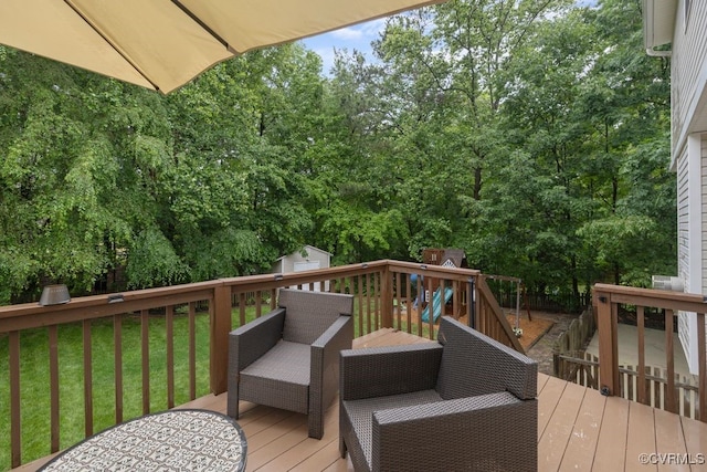 deck with an outdoor structure, a storage unit, a lawn, an outdoor hangout area, and view of scattered trees