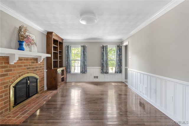 unfurnished living room featuring a fireplace, wainscoting, hardwood / wood-style floors, and ornamental molding