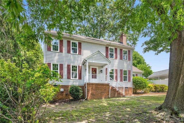colonial-style house featuring a chimney