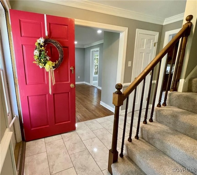 entryway with light tile patterned flooring, stairway, ornamental molding, baseboards, and recessed lighting