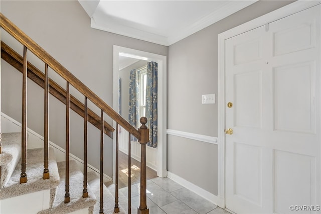 foyer featuring ornamental molding, stairs, and baseboards