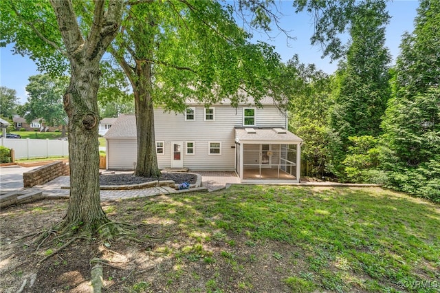 rear view of property with a sunroom