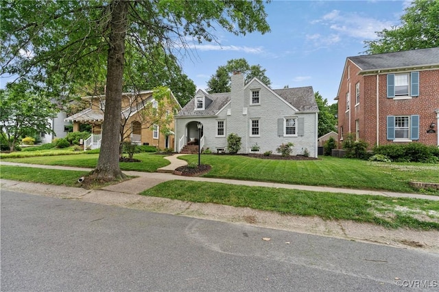 1235 Warren Ave, Richmond, VA 23227 - view of front of property with a front yard, a chimney, and brick siding