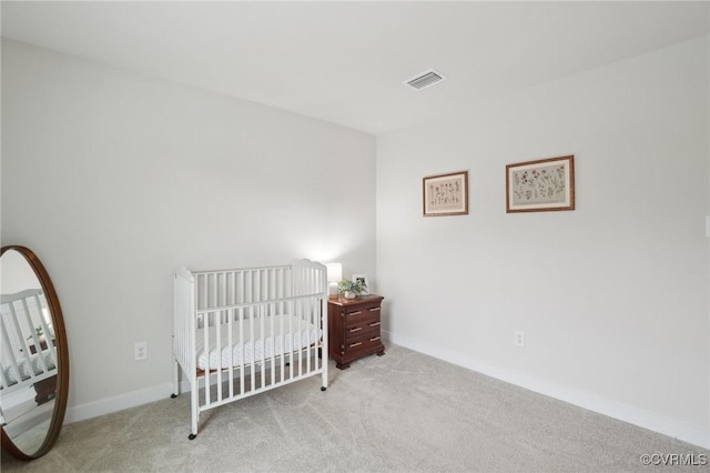 bedroom featuring carpet floors, baseboards, and a nursery area