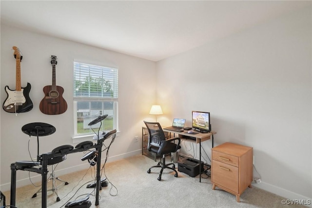 office space featuring light carpet and baseboards