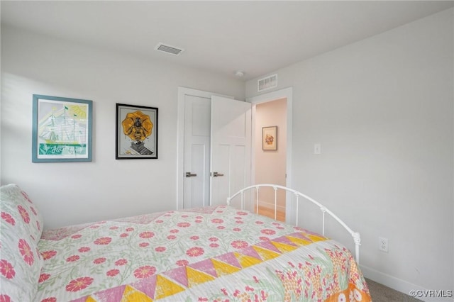 carpeted bedroom with a closet and baseboards