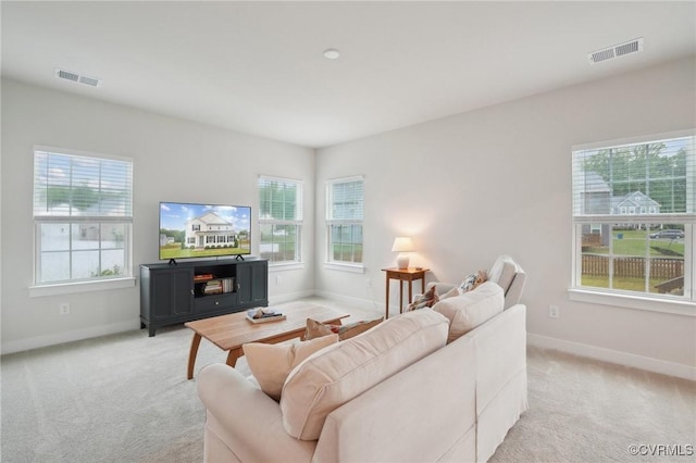 living room with baseboards and light colored carpet