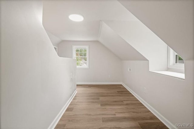 201 W Roanoke St, Ridgeway, VA 23225 - additional living space with wood finished floors, lofted ceiling, and baseboards
