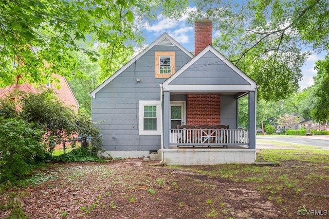 201 W Roanoke St, Ridgeway, VA 23225 - view of front facade featuring a porch and a chimney